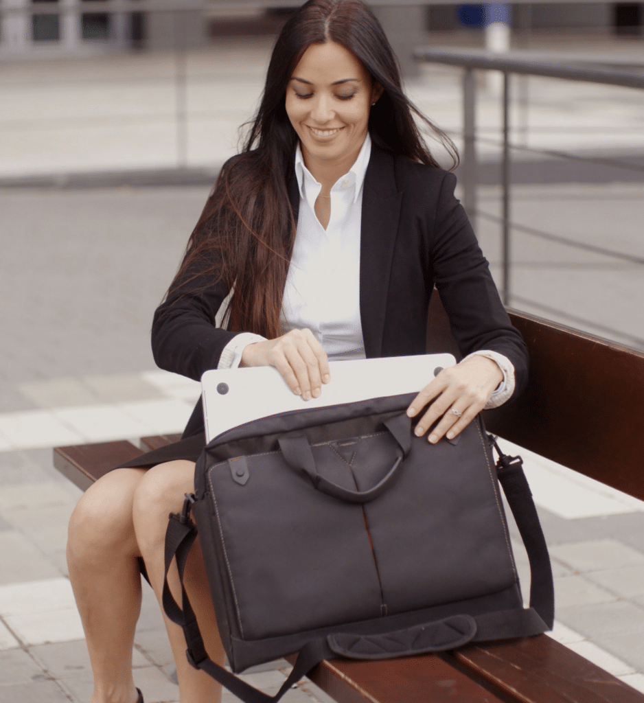 Women Putting Laptop in a Messenger Bag